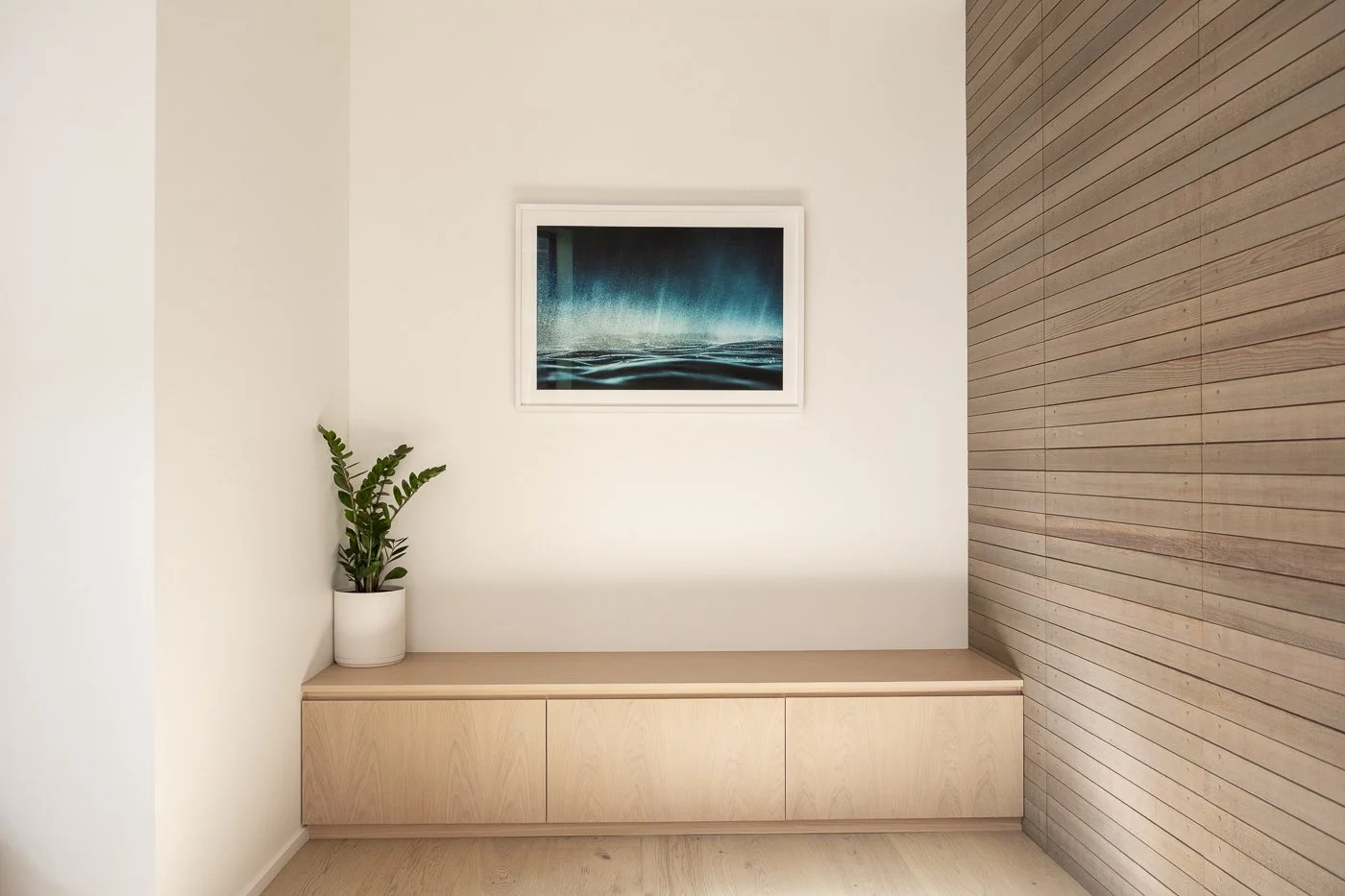 A1 fine art photography print in white frame with mat board displayed on hallway wall in modern coastal beachfront home