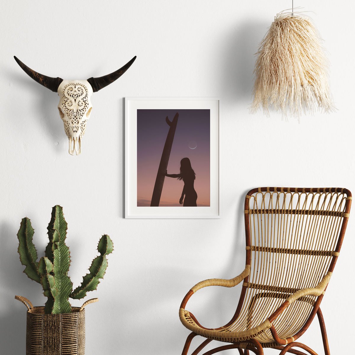 Fine art print of a female surfer and her board silhouetted against a crescent moon, framed and displayed in a boho coastal home. A stunning accent piece.