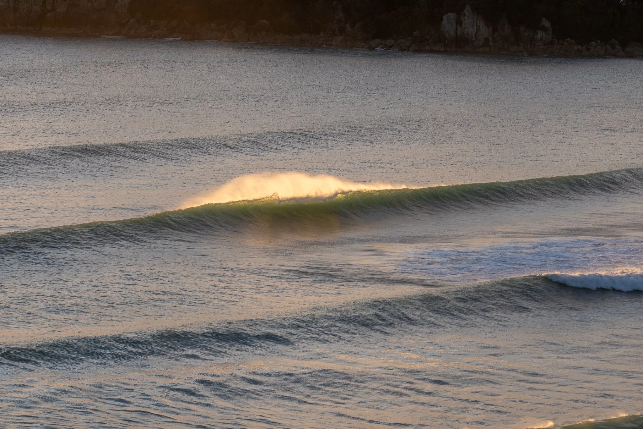 Wave breaking at sunrise in Mount Maunganui New Zealand