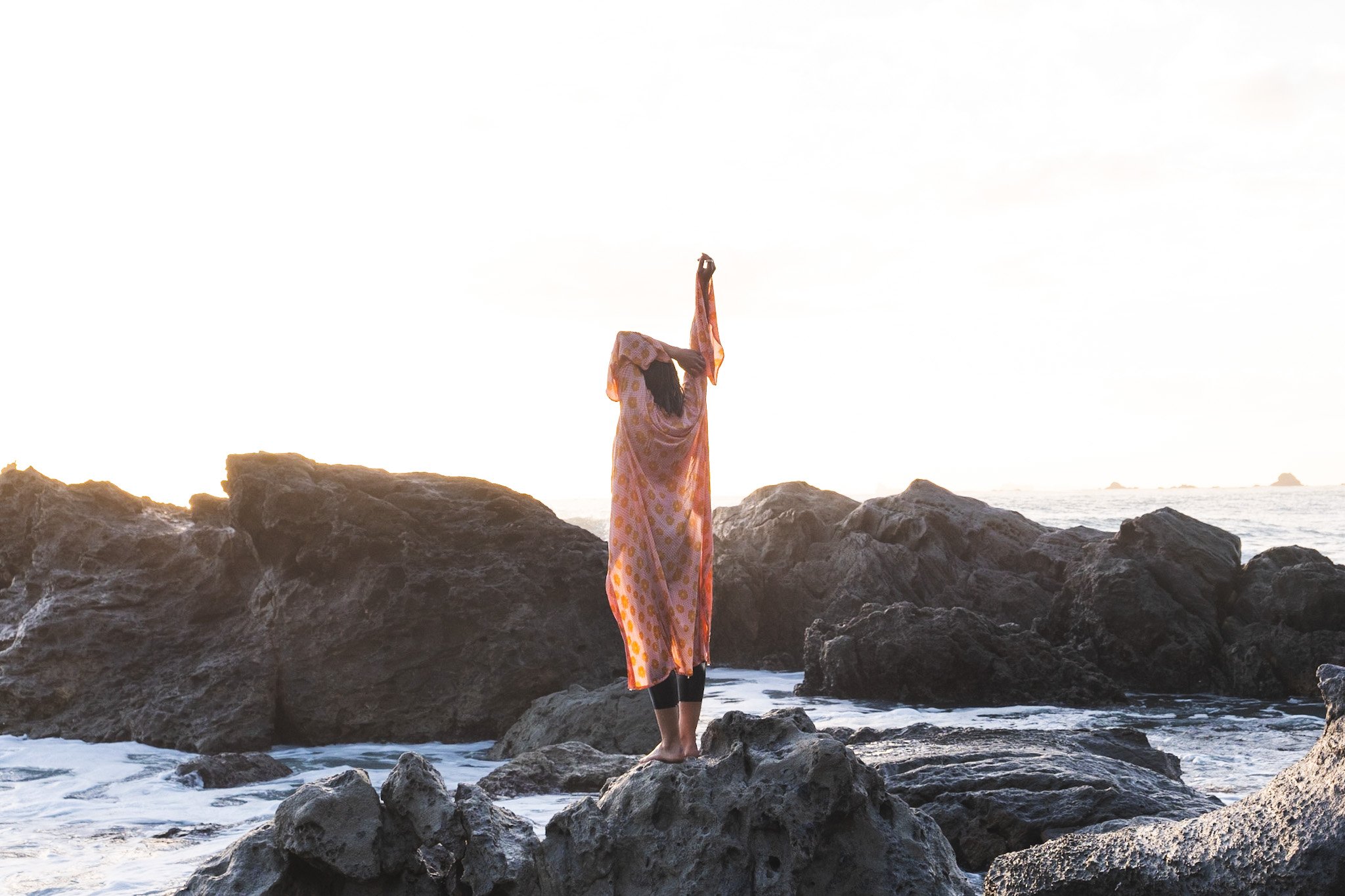 Woman at sunrise wearing boho kimono in Mount Maunganui New Zealand