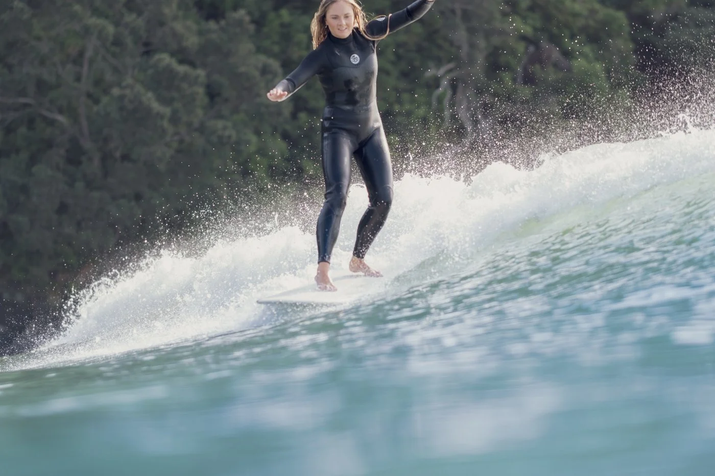 Surfer riding a wave photographed from inside the water using a surf photography in-water camera housing