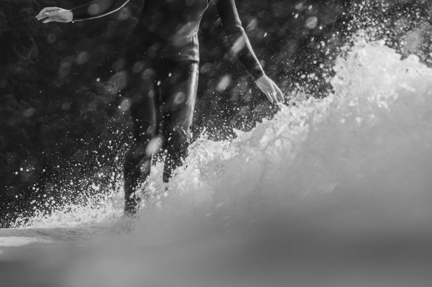 80mm in-water surf photography example showing compression spray texture and surfer detail