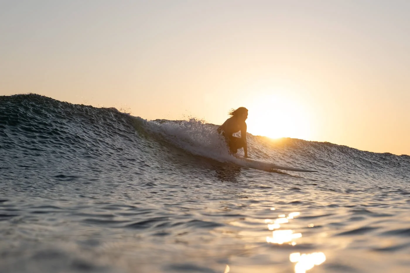 in-water surf photography example showing surfer riding wave using 16–55mm lens perspective