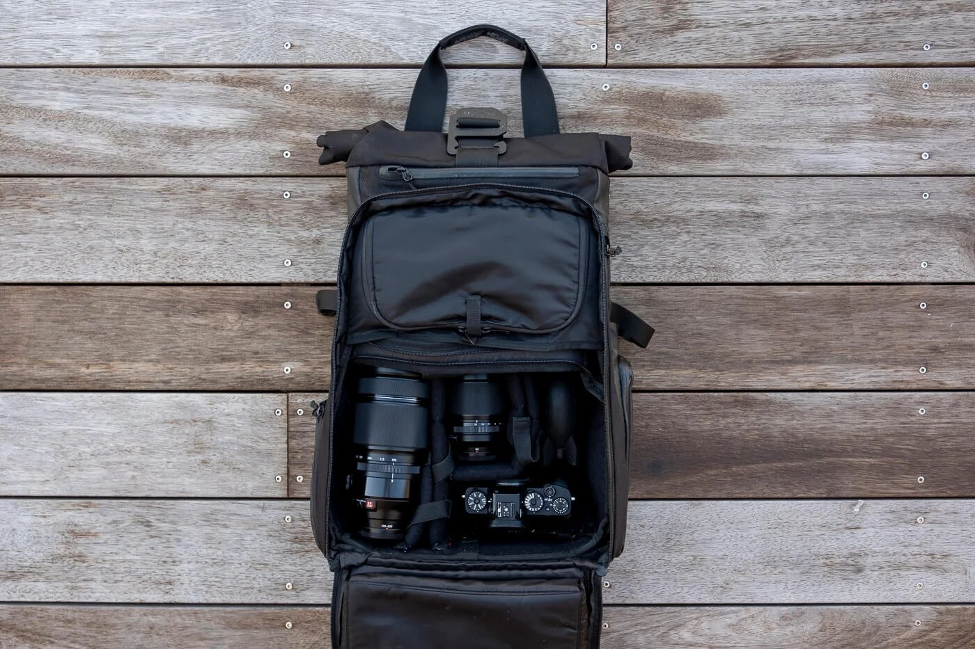 WANDRD PRVKE camera backpack organised with mirrorless camera lenses and accessories for surf photography