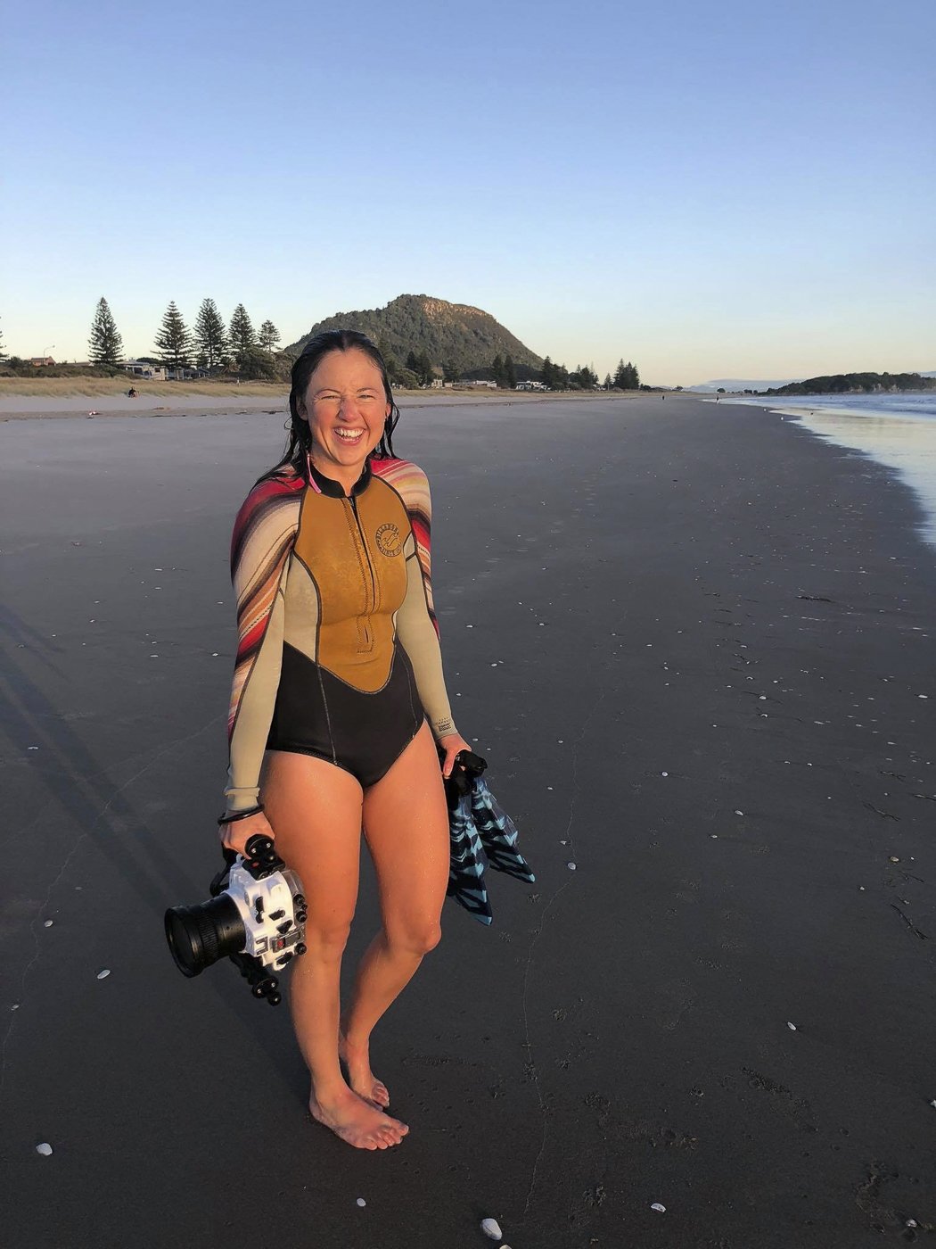 Lou Burton on the beach with underwater camera housing, creative living