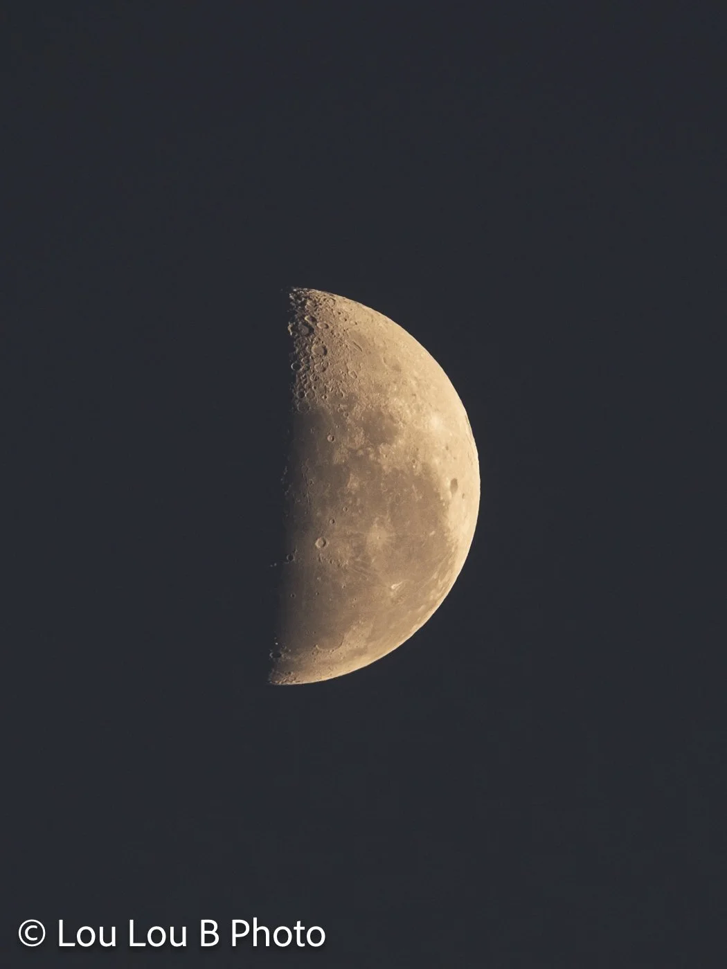 Crescent moon glowing against a deep blue evening sky.