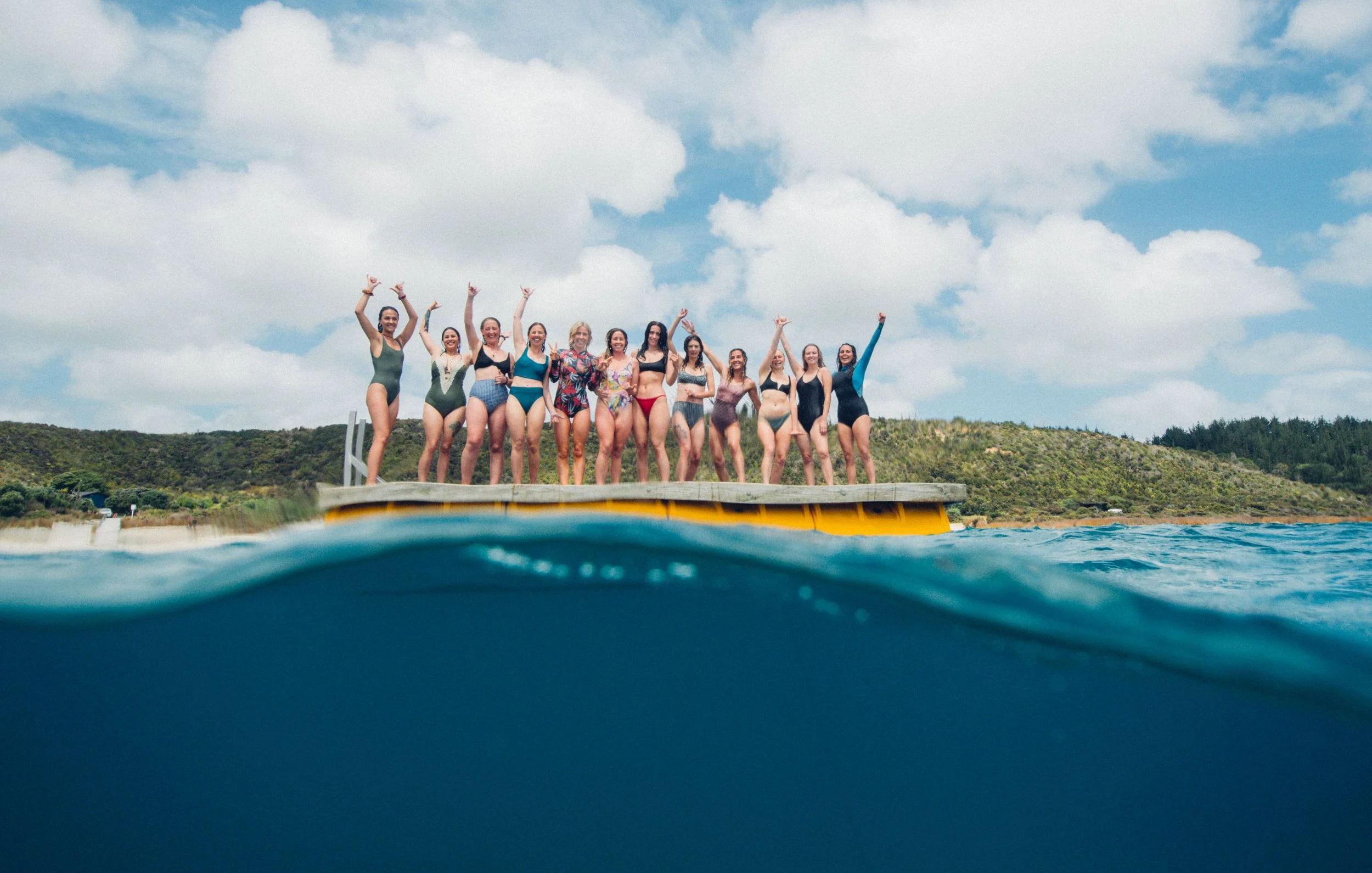 Group of women preparing for a freediving session at the clear blue Kai Iwi Lakes in Northland, New Zealand