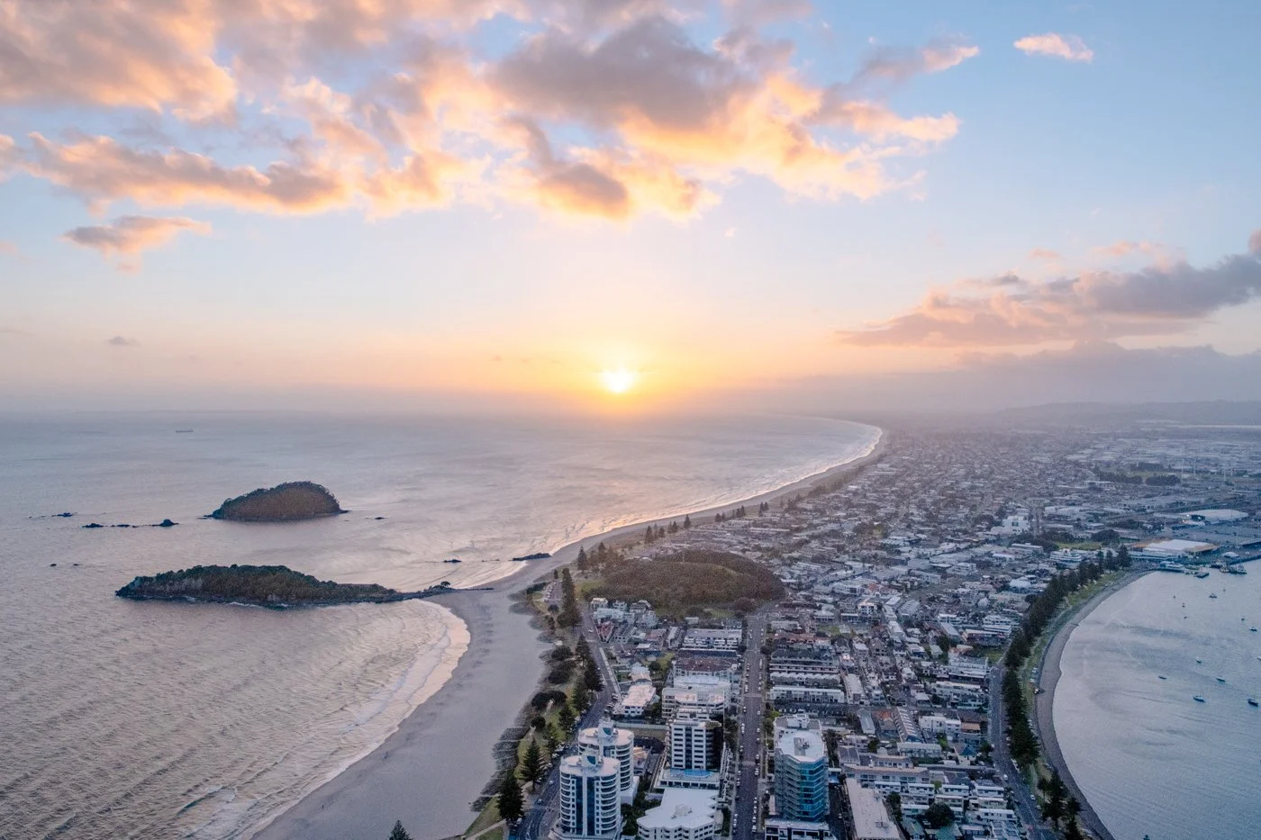 Sunrise view from Mauao summit Mount Maunganui looking across the Bay of Plenty coastline and harbour entrance