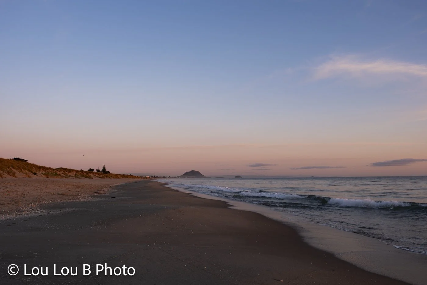 Mount Maunganui beach and Mauao under a soft pastel morning sky