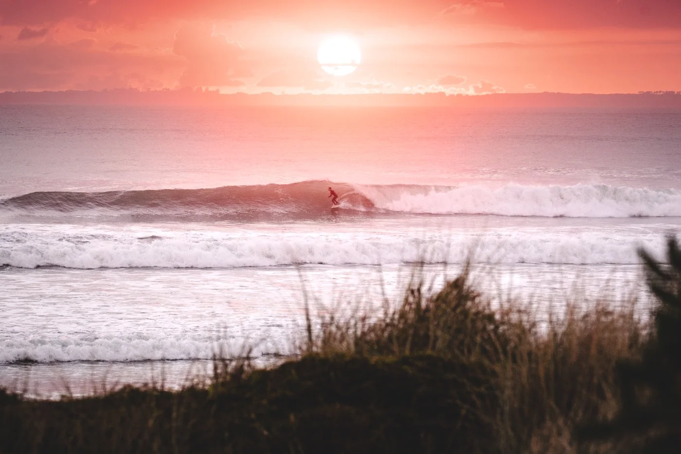 Sunrise surfer at Tay Street Beach Mount Maunganui with early morning light over the Pacific Ocean