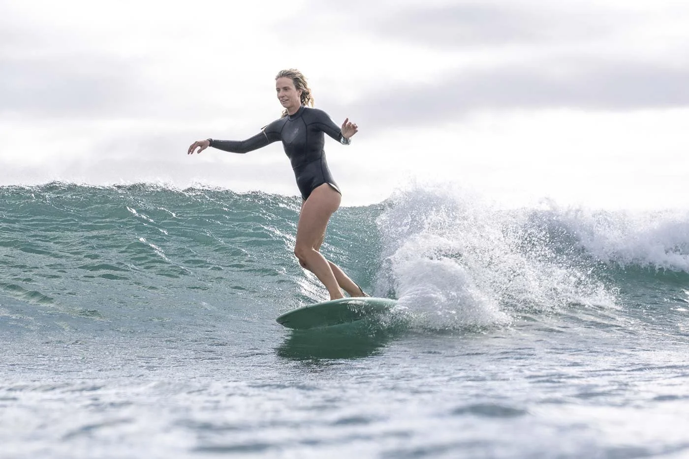 Surfer riding a clean small wave illustrating positioning and timing in surf photography