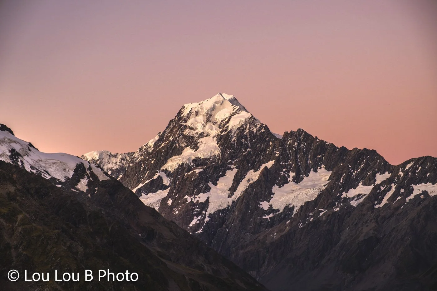 Summer snow-covered mountain peak of Aoraki Mount Cook at sunset in Aoraki / Mount Cook National Park, New Zealand