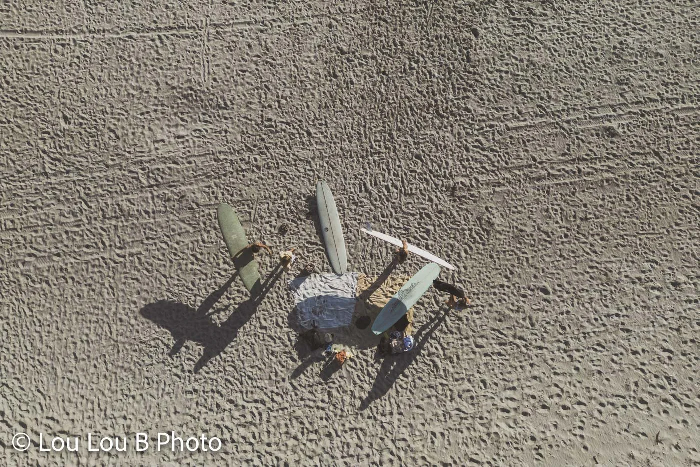 Aerial view of surfers with surfboards on the sand at Mount Maunganui beach