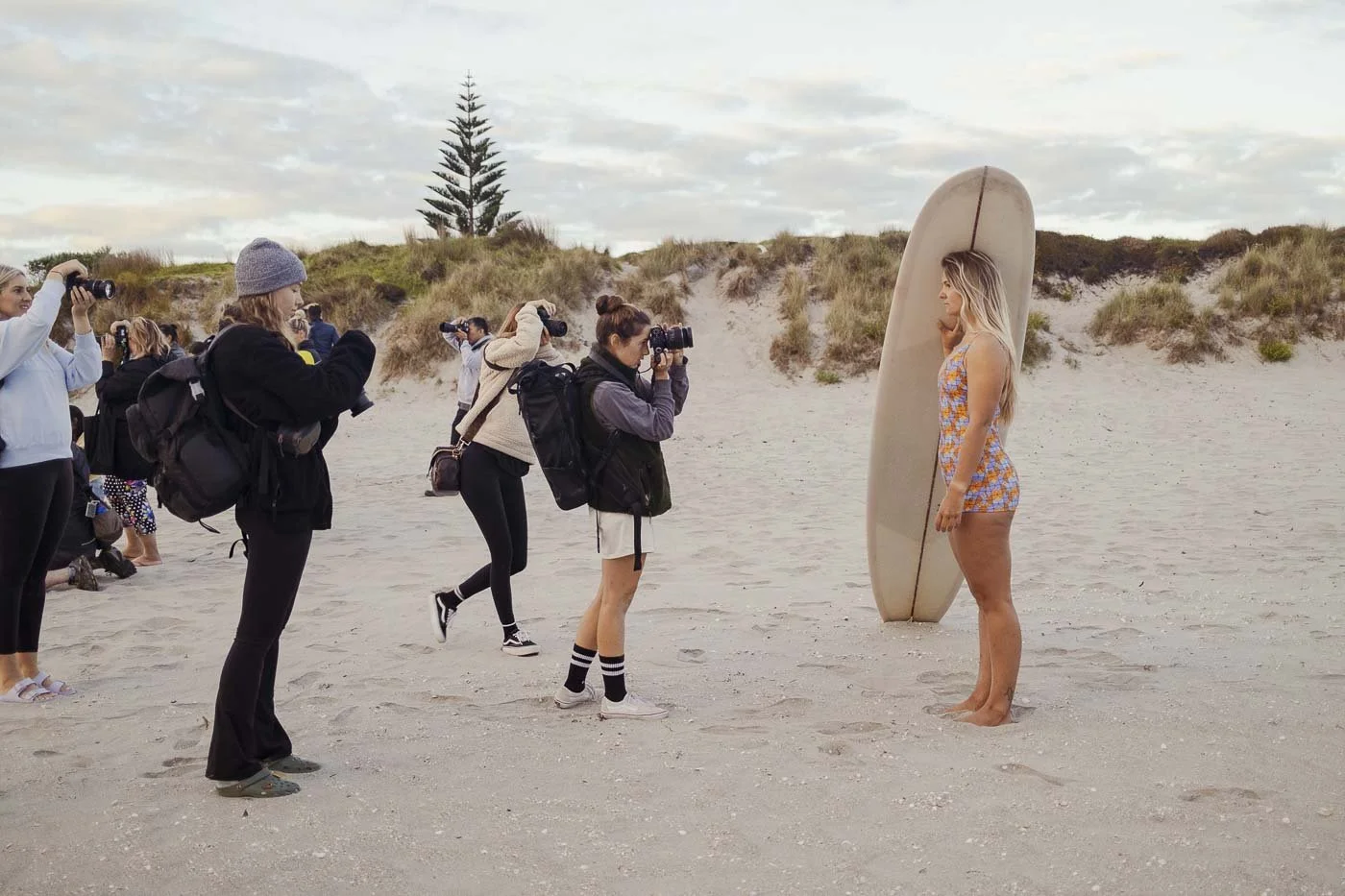 photographers capturing model with longboard during Nostalgic Surf styled surf photography workshop retro swimwear styling beach campaign shoot wardrobe direction