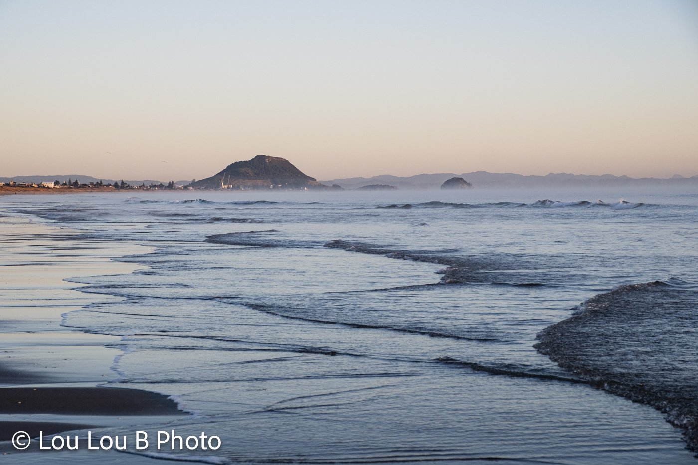 Mount Maunganui coastline and Mauao in soft pastel light from the beach