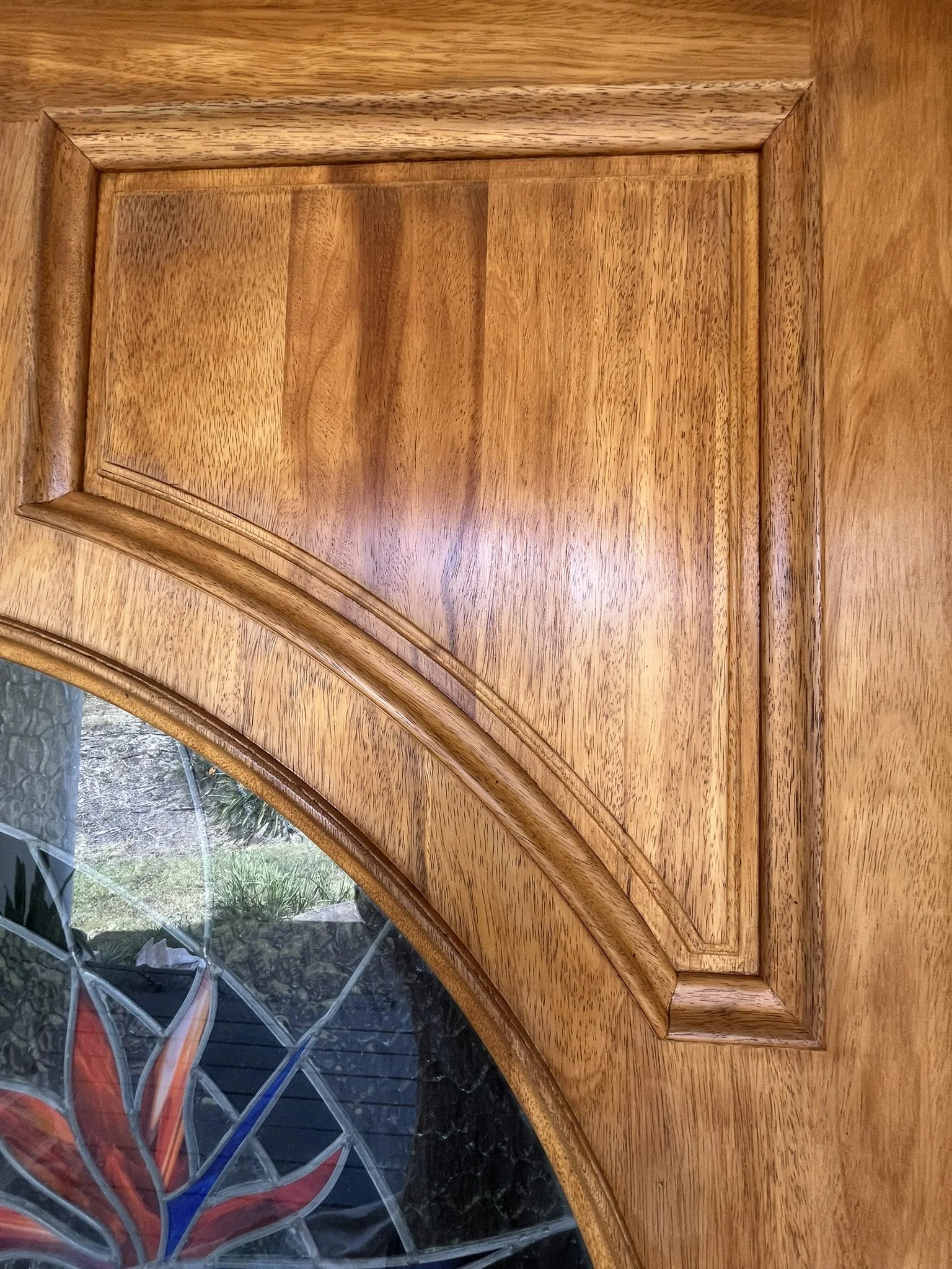 Cabinet refinishing in a Maui home - close-up of a wood cabinet door with detailed molding, by Maui Home Refinishing.