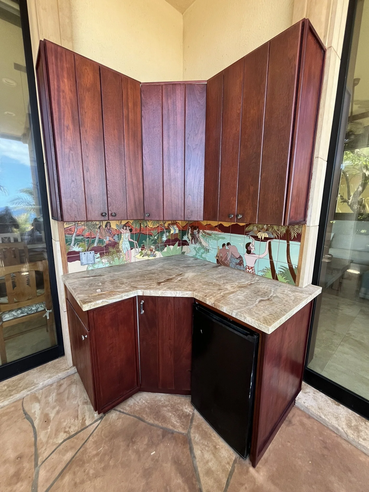 Cabinet refinishing in a Maui home kitchen - corner wood cabinets with marble countertop, by Maui Home Refinishing.