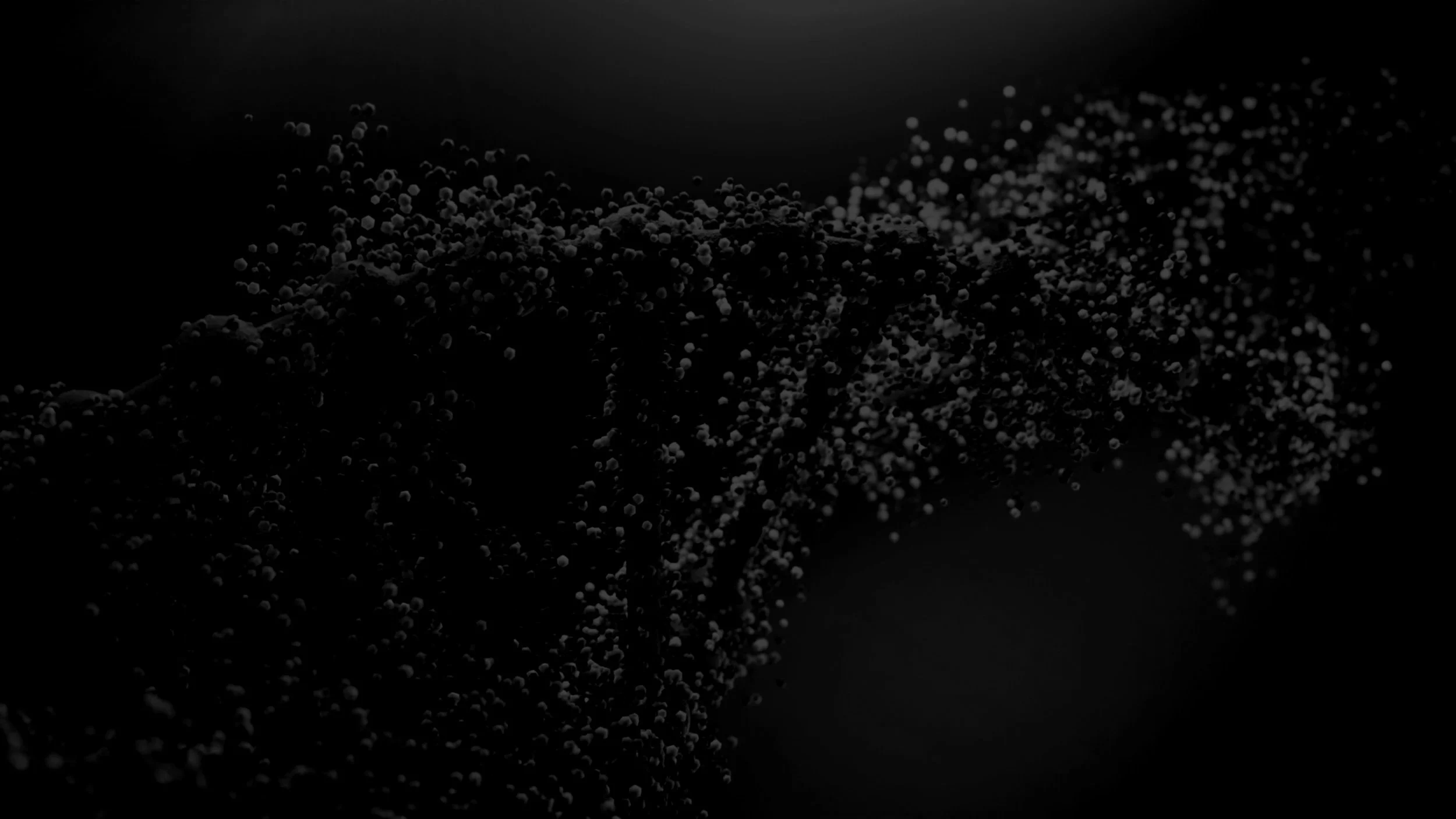 A dark background with scattered small white particles resembling snow or dust in a swirling pattern.