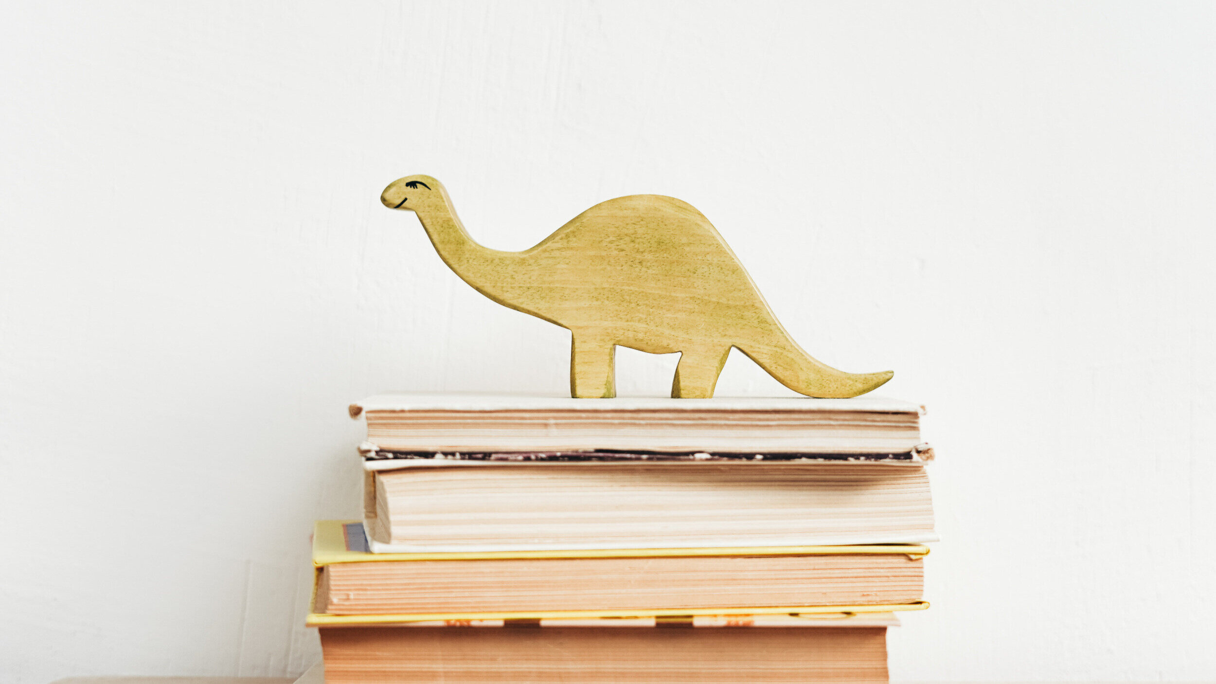 dinosaur-cutout-on-stack-of-books.jpg