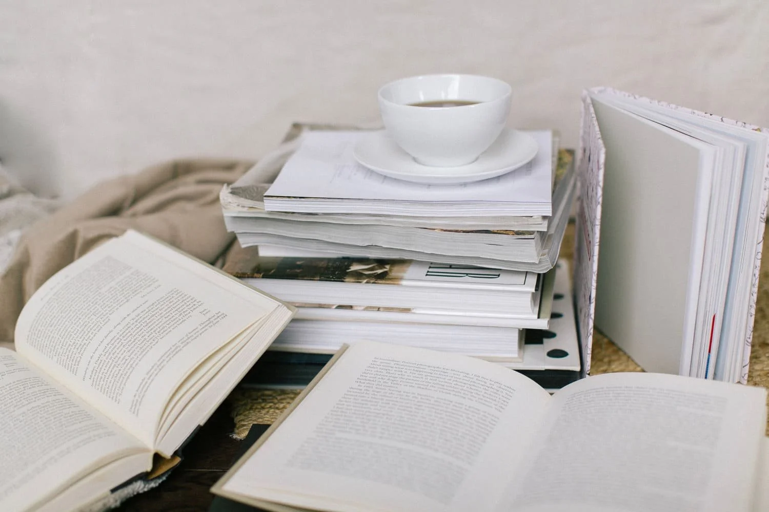 A stack of open books, representing family history research to then write into a narrative.