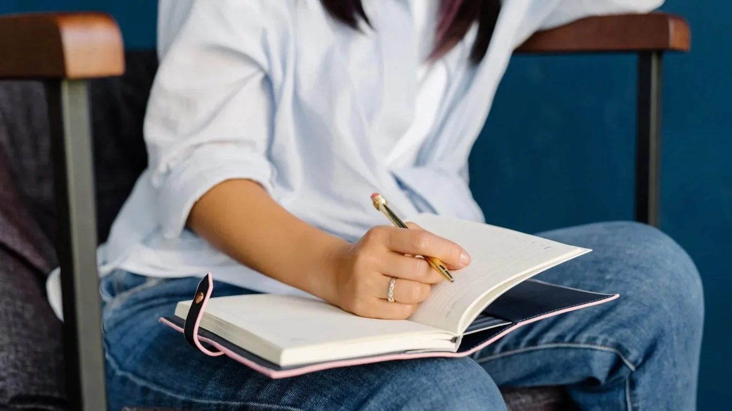 An author planning a multi-book nonfiction series, taking notes in a journal, representing how to write a nonfiction book series