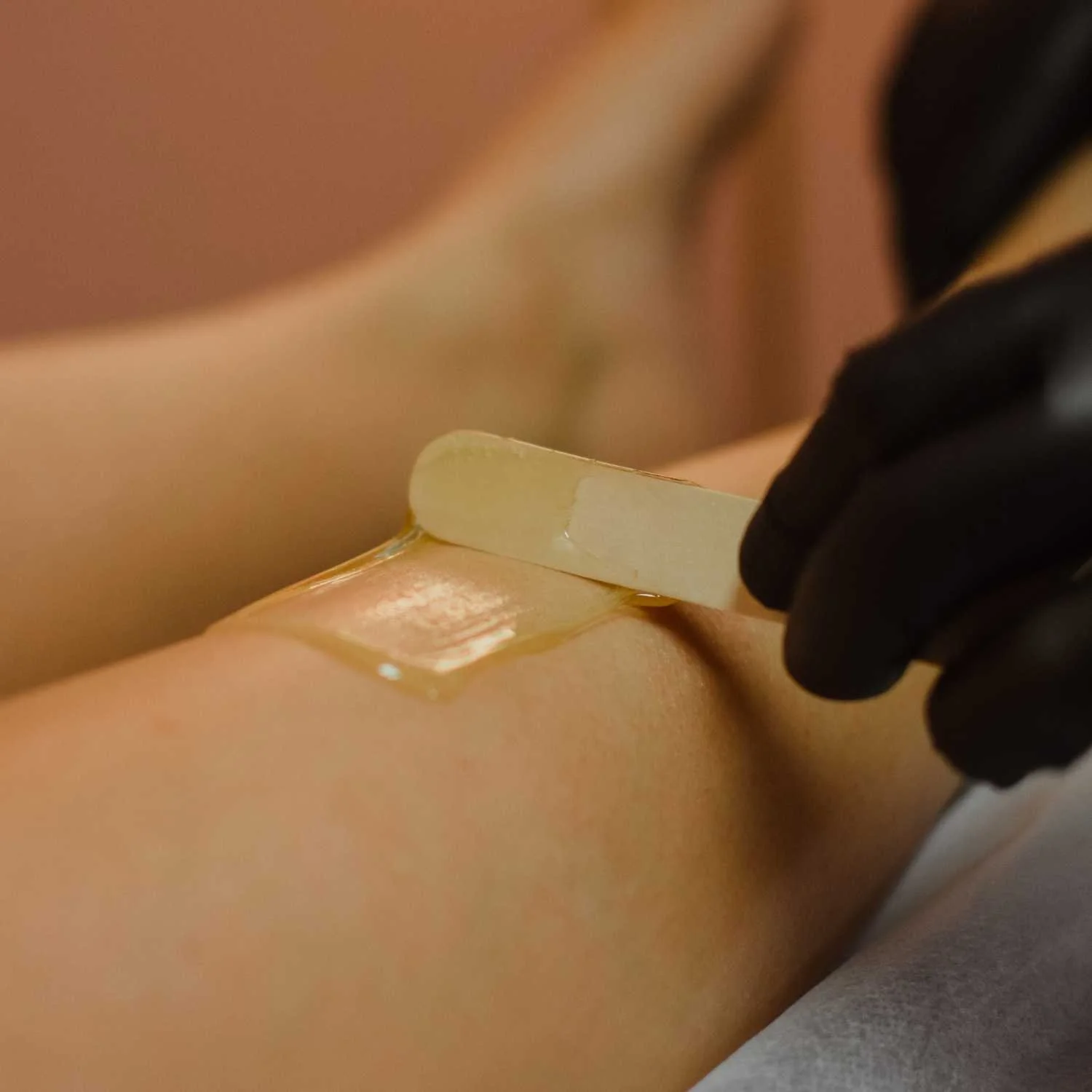 Close-up of soft wax on a wooden applicator