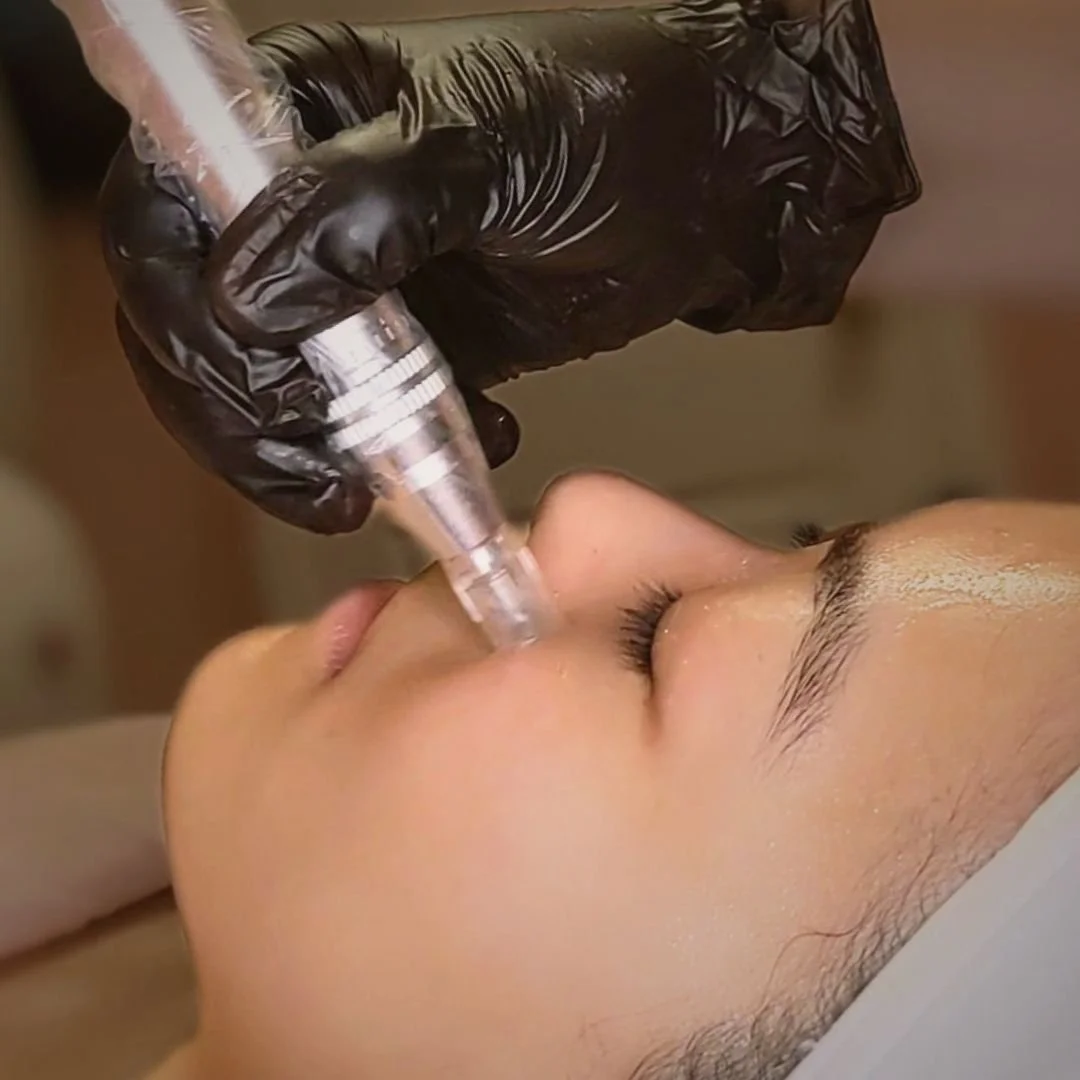 A person receiving a facial treatment, while lying down with closed eyes.