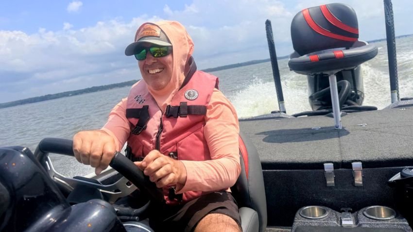 Driving a bass boat wearing Academy Magellan Sun Hoodie SPF