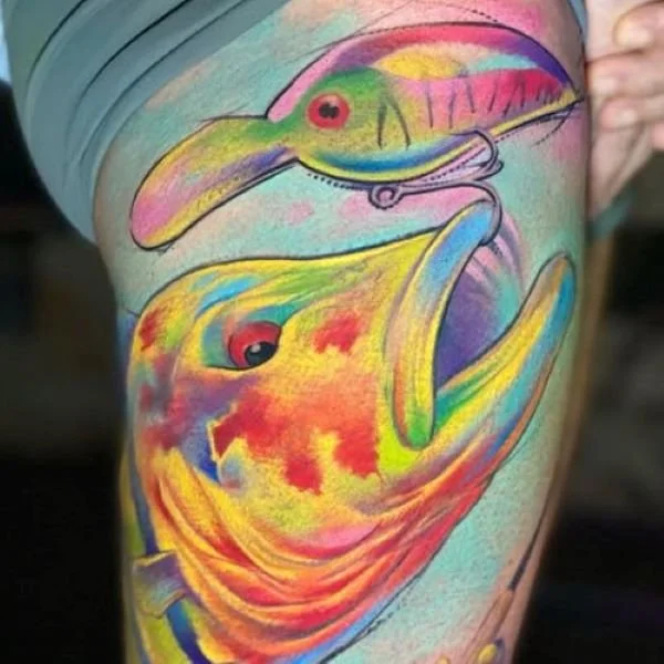 Tattoo peacock bass fish eating a crankbait