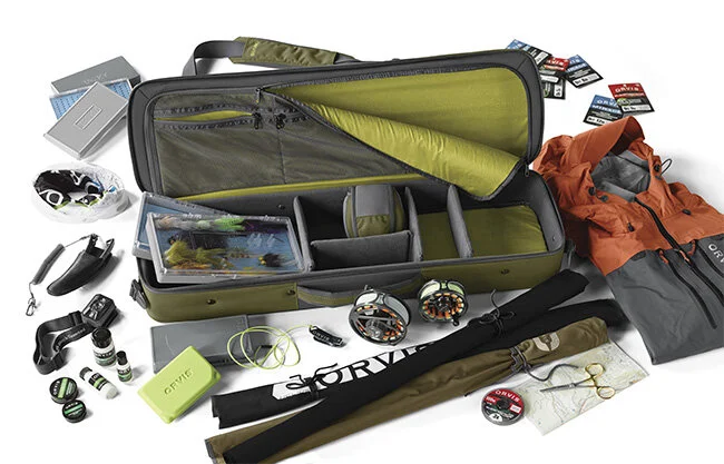 fishing luggage stuffed to the gills with equipment and tools