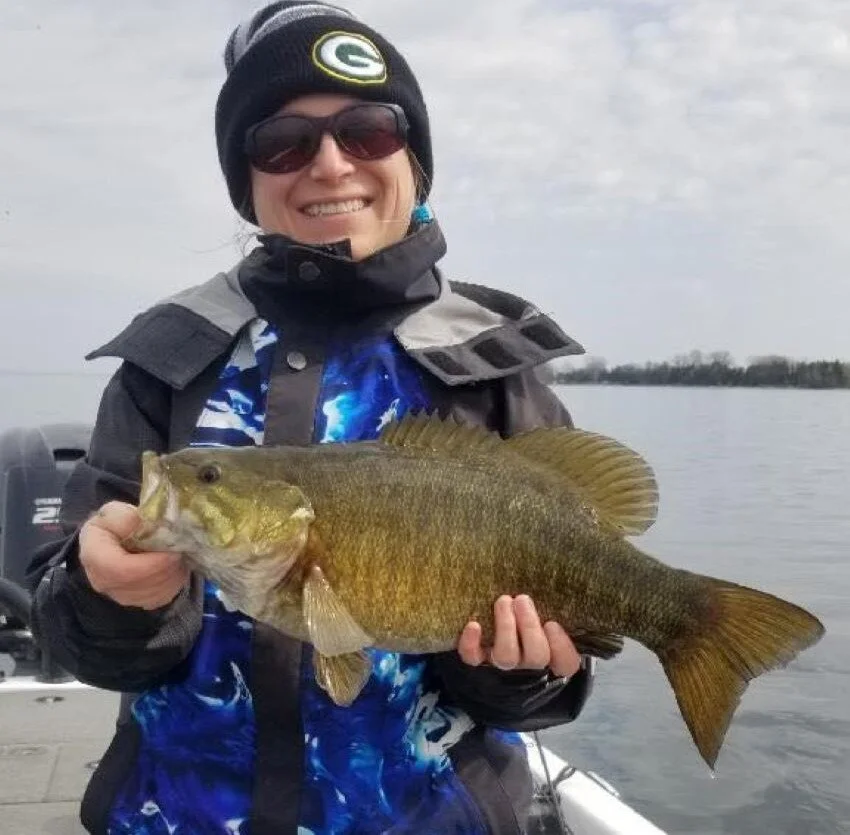 Samantha Sukupcak of Milwaukee fishes the BASS Nation and Bass Federation tournaments in her HUK rain gear and Green Bay Packers hat