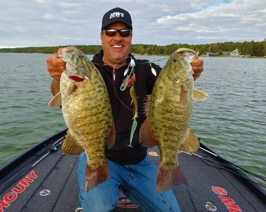 Mark Zona with two smallmouth bass caught on a castable umbrella rig