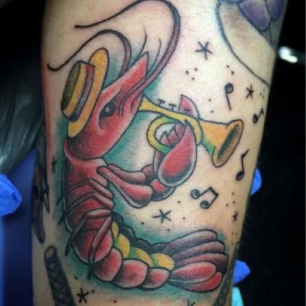 New Orleans crawfish tattoo playing trumpet