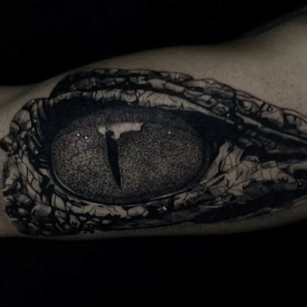 spooky caiman eyeball tattoo black and white