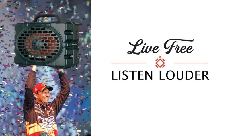 Kevin VanDam hoisting a Turtle Box portable waterproof speaker