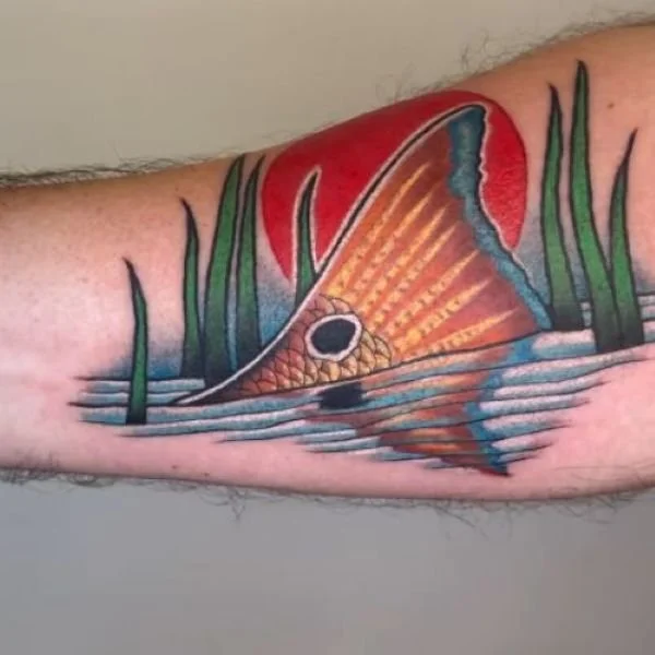Colorful spotted redfish tail tattoo