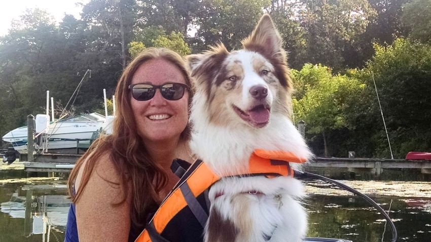 woman with a red merle aussie