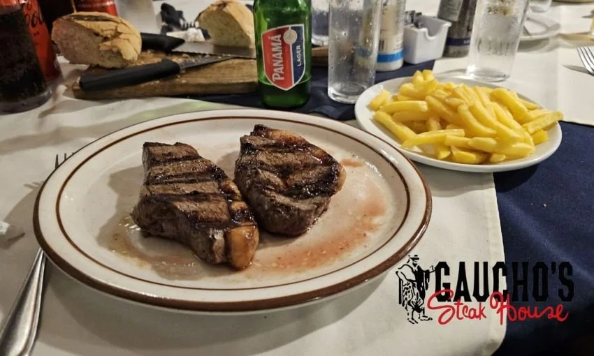 steak, french fries and beer at Gaucho's Steak House Panama City