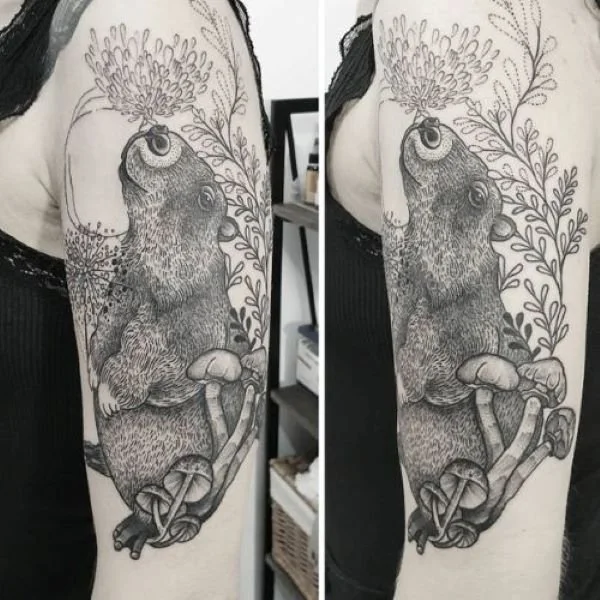 highly detailed black and white tattoo of a capybara in a garden