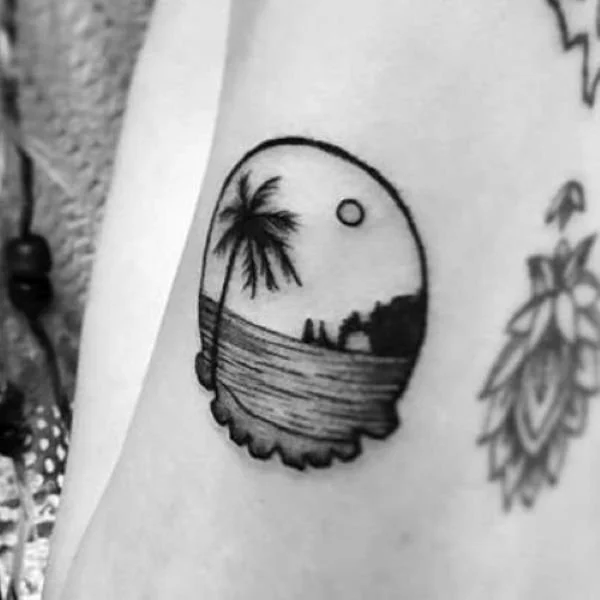 Black and White tattoo Cabo Arch with single palm tree