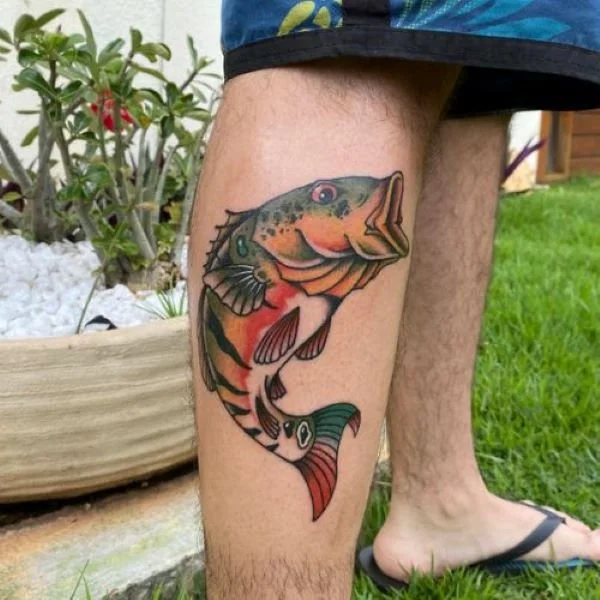 Colorful leg tattoo peacock bass jumping