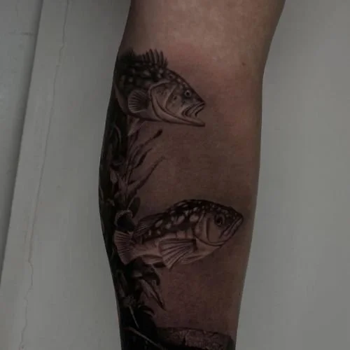 black and white tattoo of two calico bass