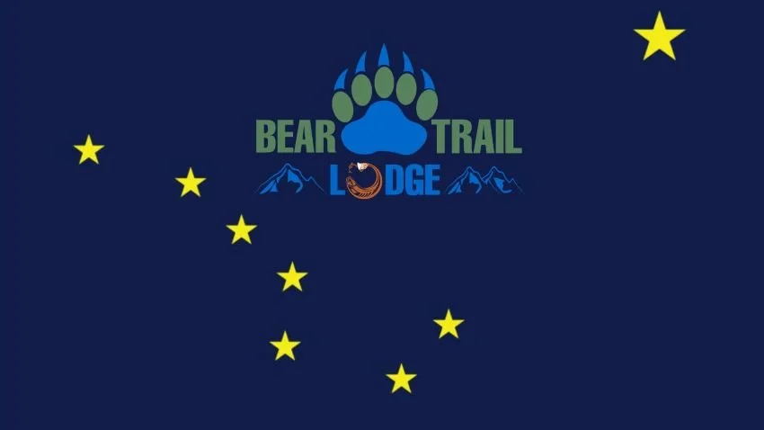 Bear Trail Lodge logo over Alaska flag