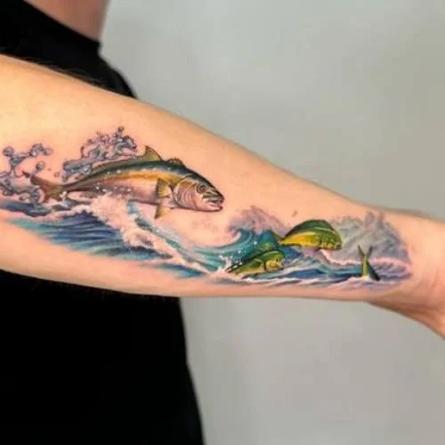 Tattoo of yellowtail chasing mahi through waves