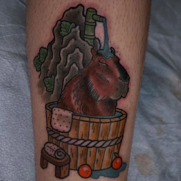 tattoo of a capybara in a barrel outdoor shower