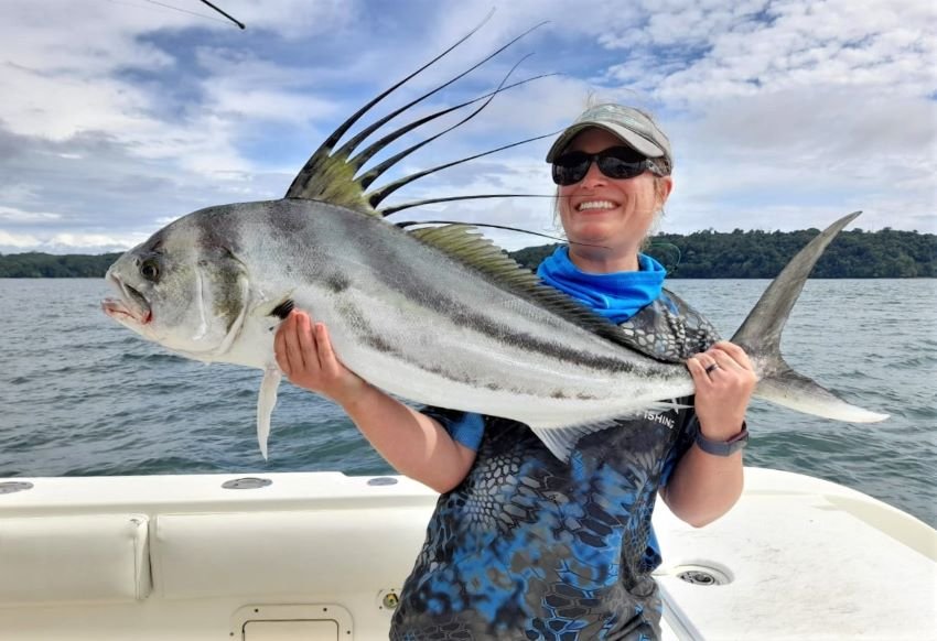 Female angler with large roosterfish caught in panama