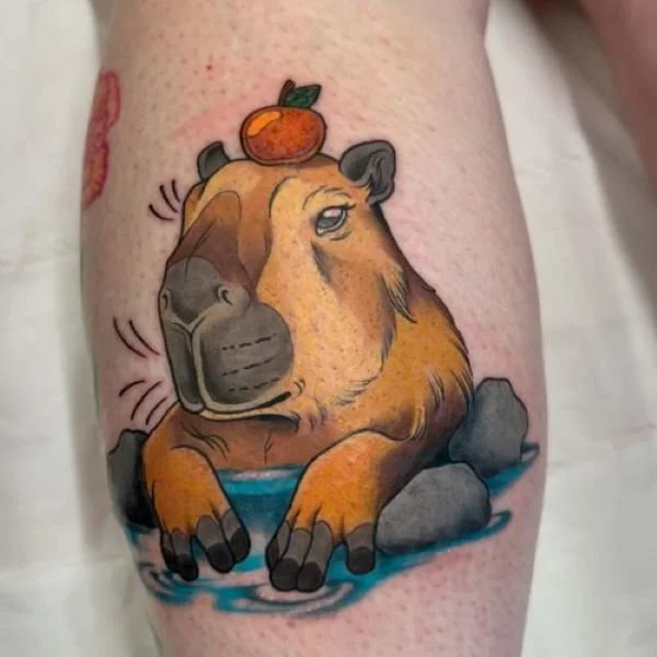 color tattoo capybara with fruit on its head