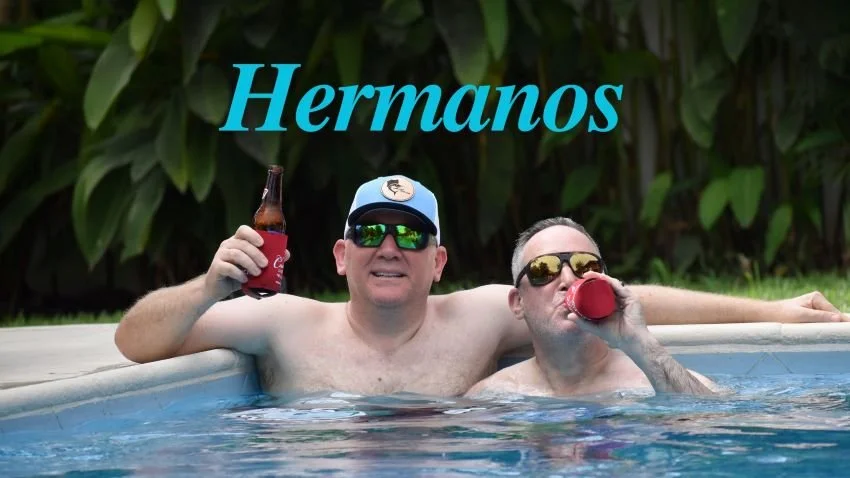 Mike and Pete Robbins in Swimming Pool drinking cerveza