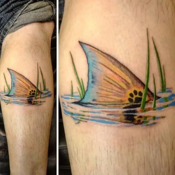 Animal House tattoo tailing redfish in reeds