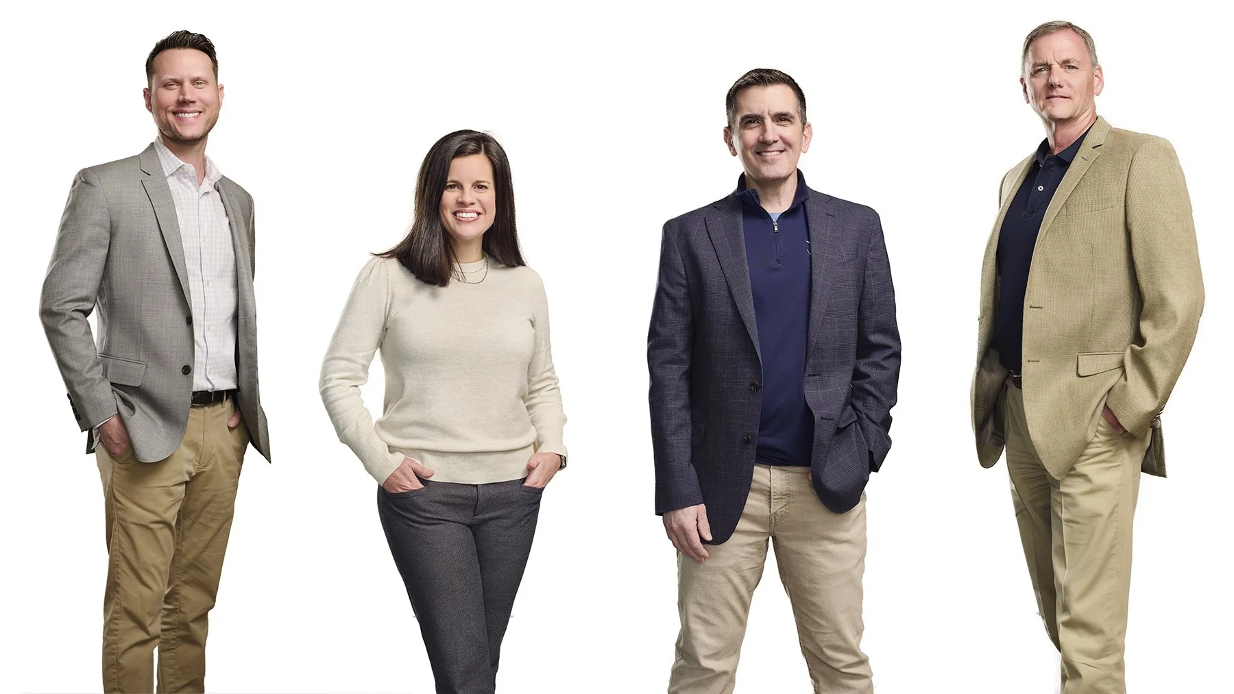 Four corporate team members photographed individually on a white background and isolated from their original backgrounds in preparation for a final composite group portrait.